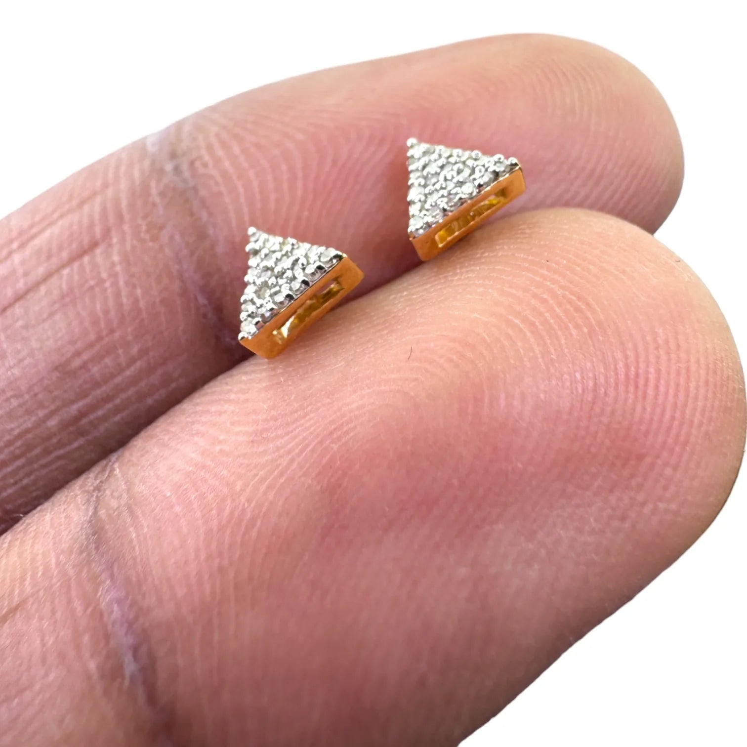 Pair of 10KT yellow gold 5mm triangle stud earrings pave-set with 0.09ct total genuine SI diamonds, shown from the back highlighting secure screw-back posts on white fabric
