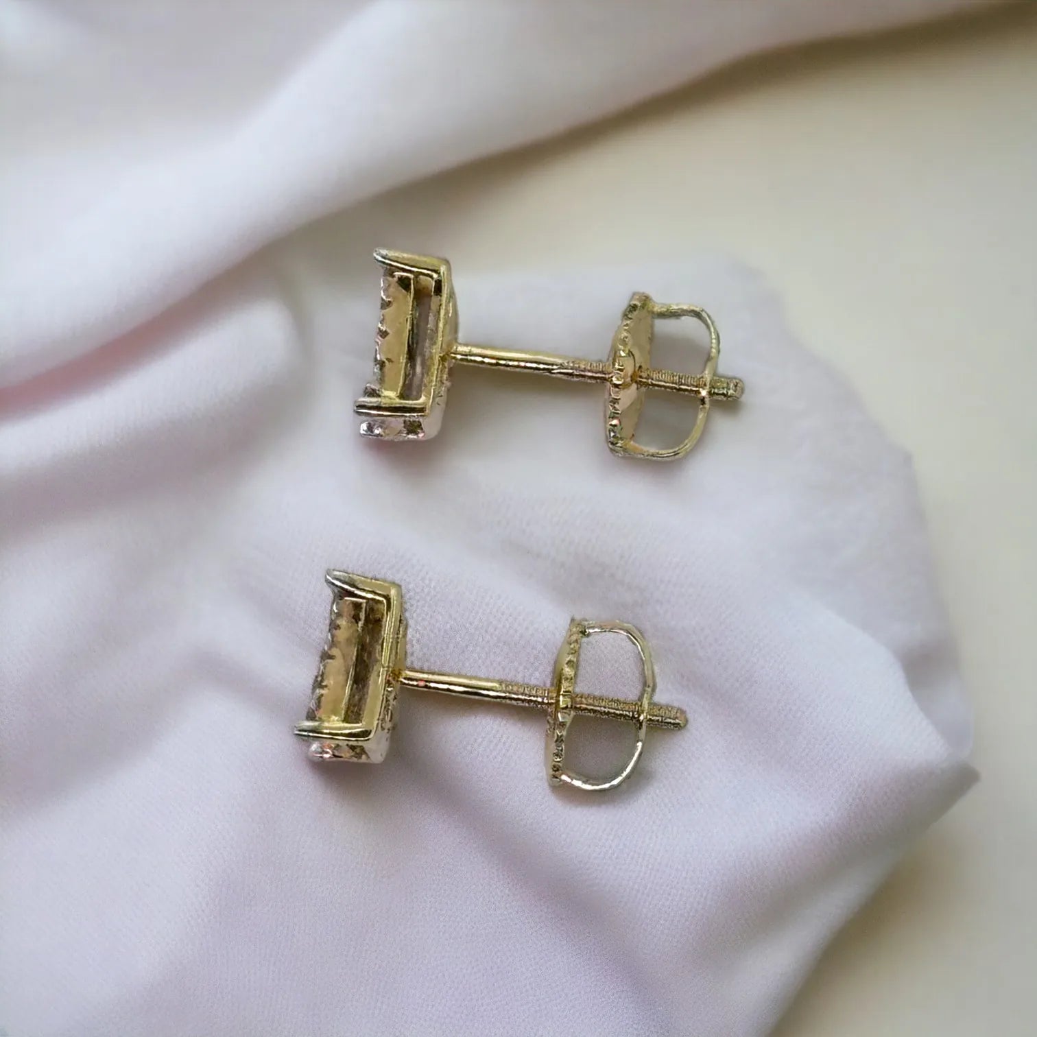 Pair of 10KT yellow gold 6mm square pave diamond stud earrings (0.26ct total genuine SI diamonds), back view clearly showing secure screw-back posts on soft white fabric