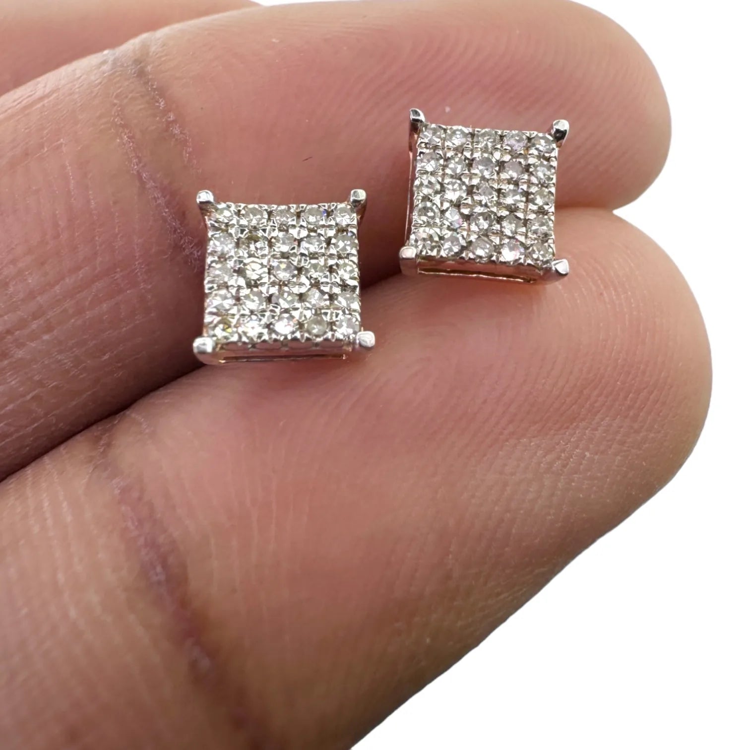 Delicate 10KT gold 6mm square pave diamond earrings (0.26ct genuine SI diamonds) held in hand to demonstrate actual size and brilliant cluster design