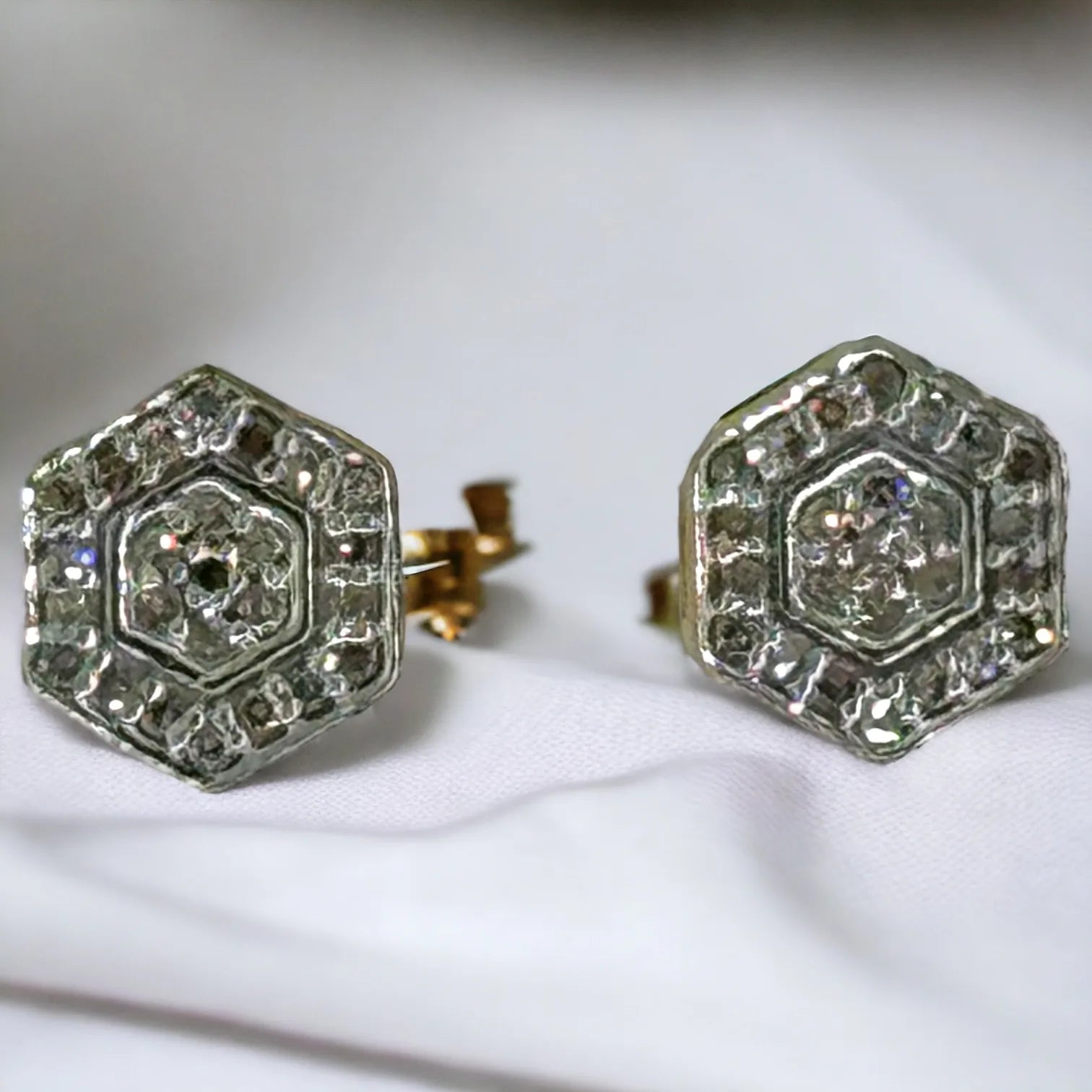 10KT yellow gold hexagon stud earrings with 0.10ct SI diamonds, pave-set in a precise geometric design, shown from the front on white background