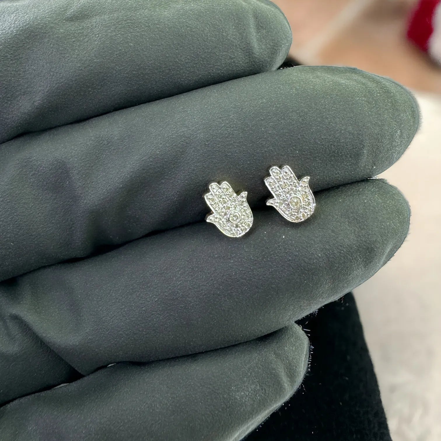 Pair of 10K yellow gold Hamsa hand stud earrings 0.12 carat total SI diamonds, symbolic protection design shown on gloved hand