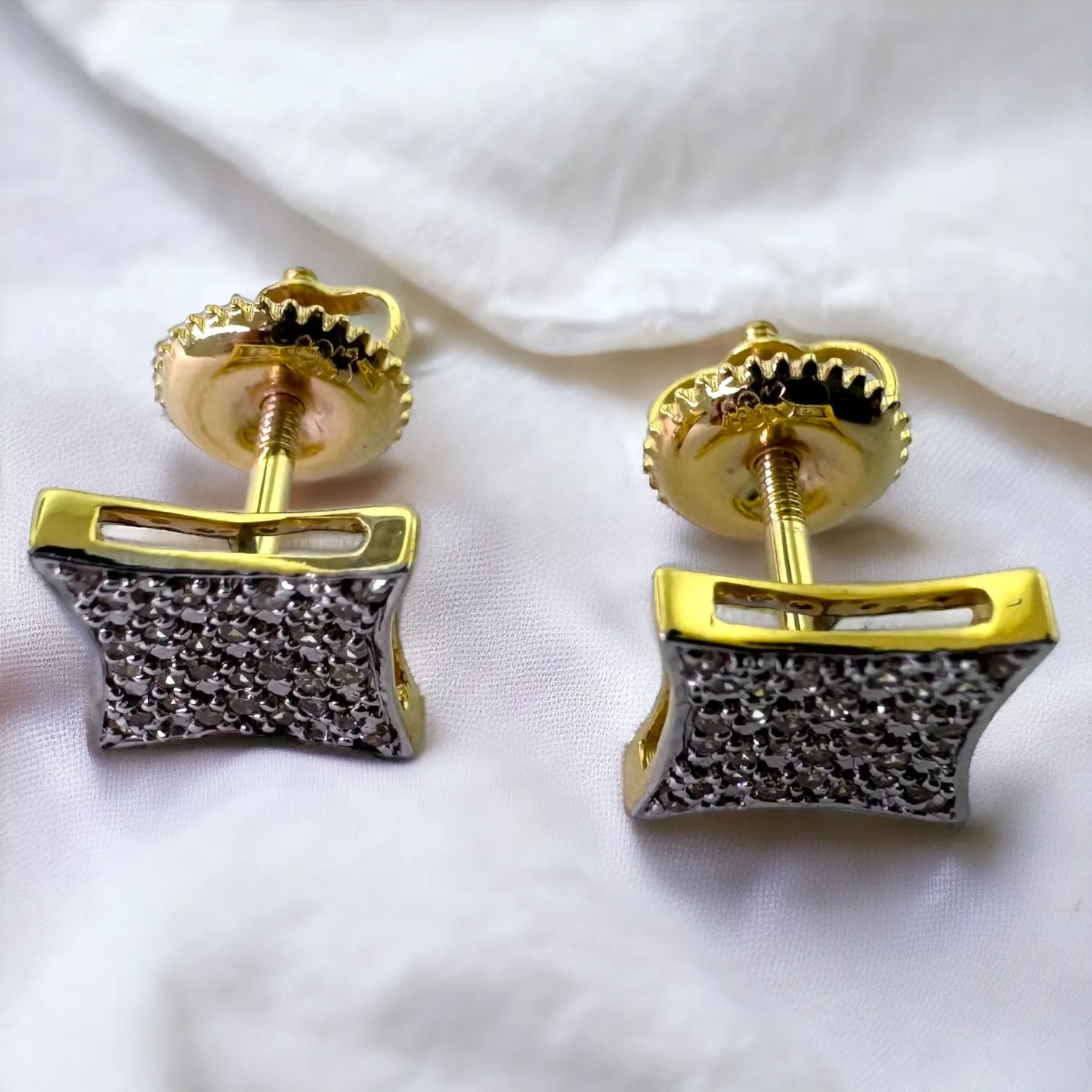 Front view of luxury 10KT gold square pave diamond stud earrings totaling 0.17 carats SI diamonds, displayed on white fabric to emphasize maximum sparkle