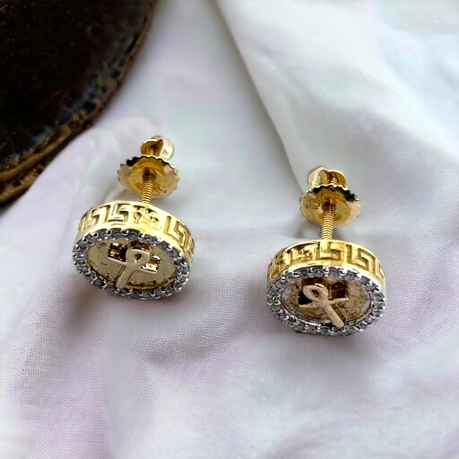 Close-up side and back view of men's/ladies' 10KT yellow gold 9mm Ankh cross pave diamond studs totaling 0.15 carats SI diamonds, highlighting secure screw-back closure and detailed craftsmanship