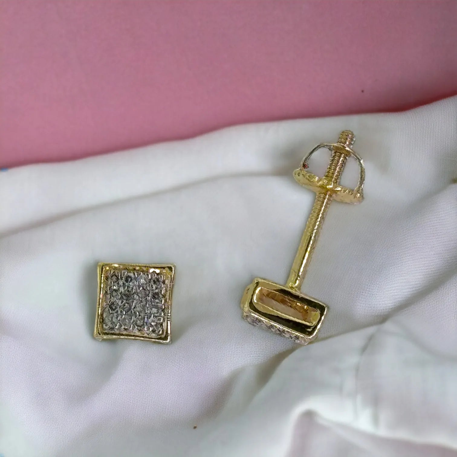 Side and back view of 10KT gold 5mm square stud earrings featuring 0.09ct genuine SI diamonds with secure screw-back posts on soft white fabric