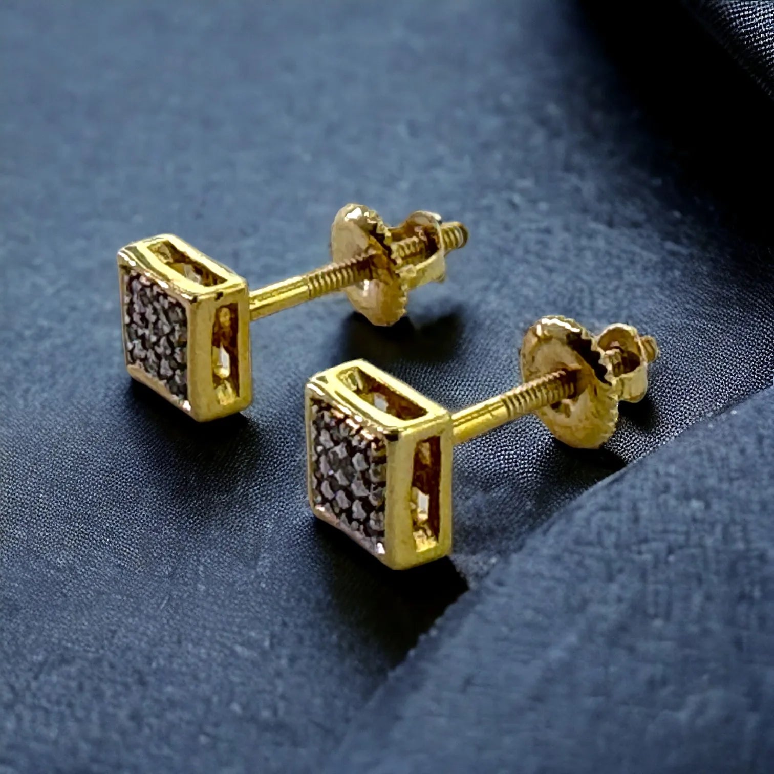 Pair of dainty 10KT yellow gold 5mm square stud earrings with 0.09 carat total genuine SI diamonds, shown against dark velvet to emphasize radiant fire and elegance