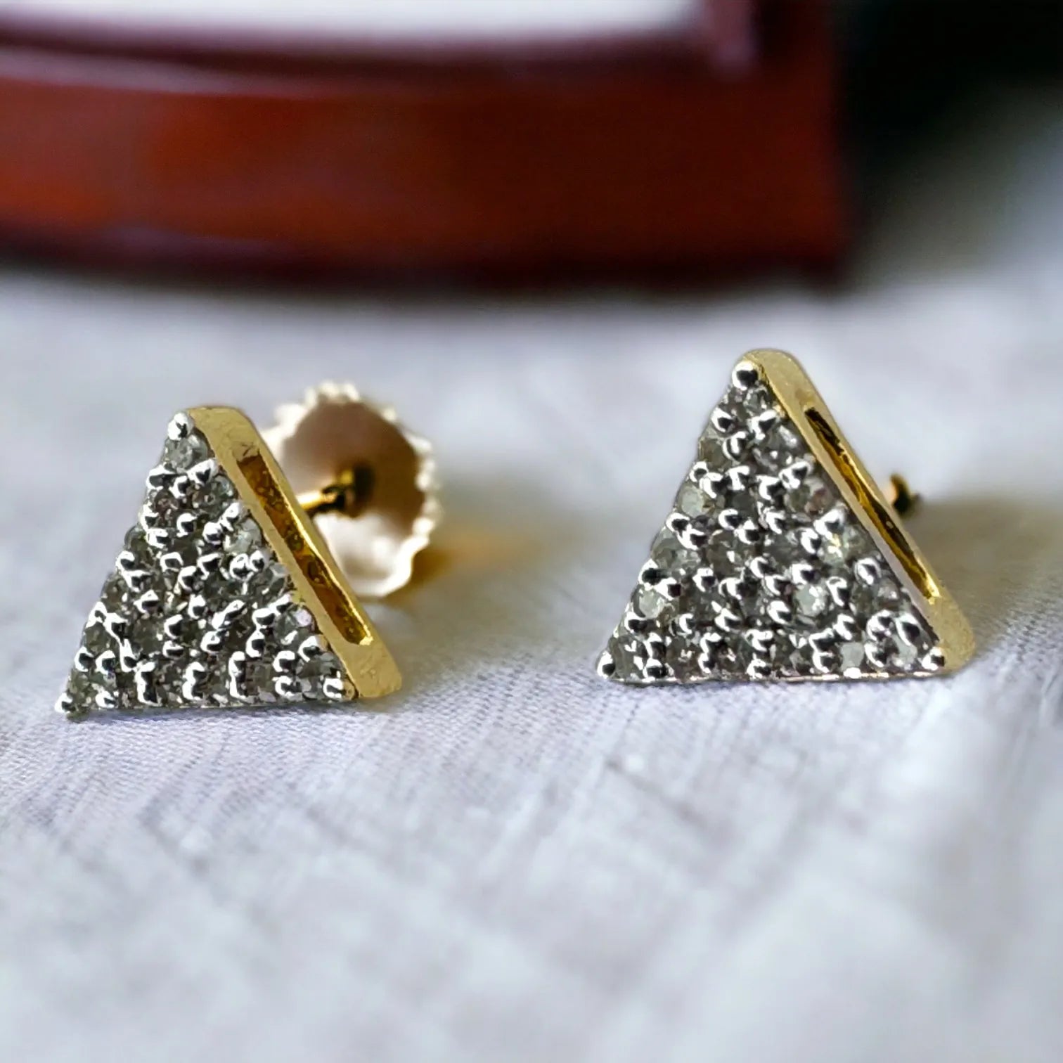 Front close-up of 10KT yellow gold 5mm pave triangle studs featuring 0.09 carat total SI diamonds, displayed on clean white background