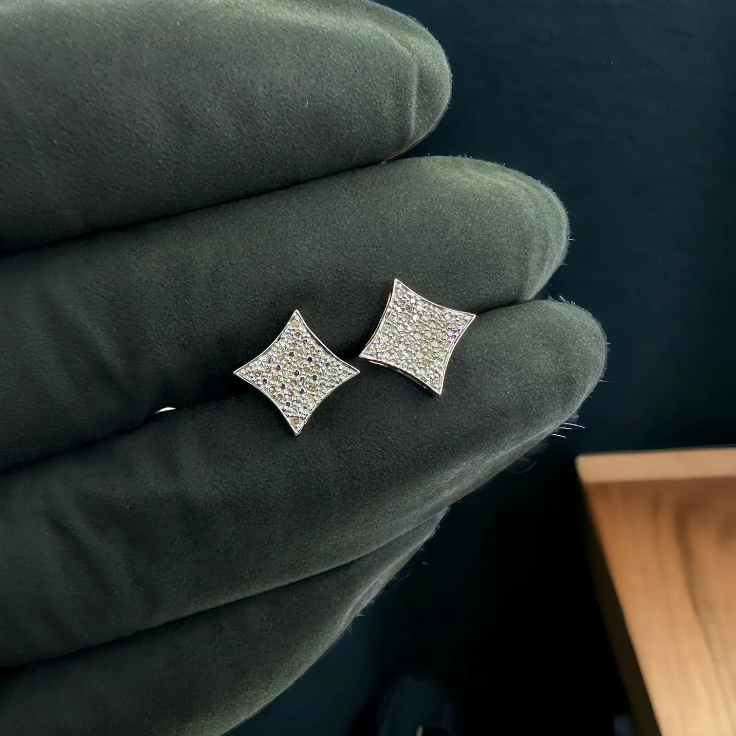 10KT yellow gold 8mm square stud earrings fully pave-set with 0.17 carat genuine SI diamonds, held in gloved hand to show actual size and brilliance